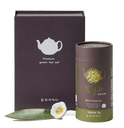 Jaksul Green Tea canister with gift box packaging and decorative tea scoop on a white background